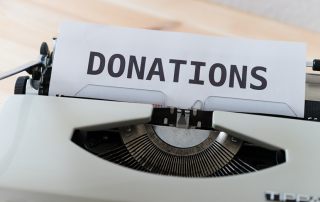 Image showing a typewriter with the word "donations".